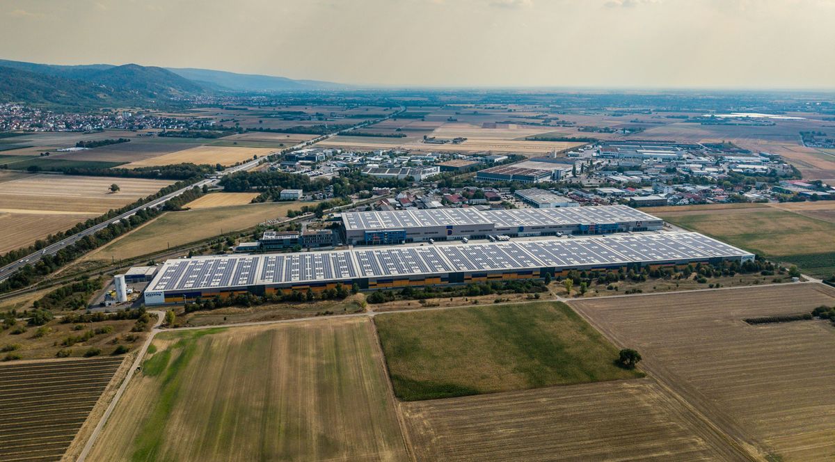 Warehouses with solar panels on their roofs in flat farmland
