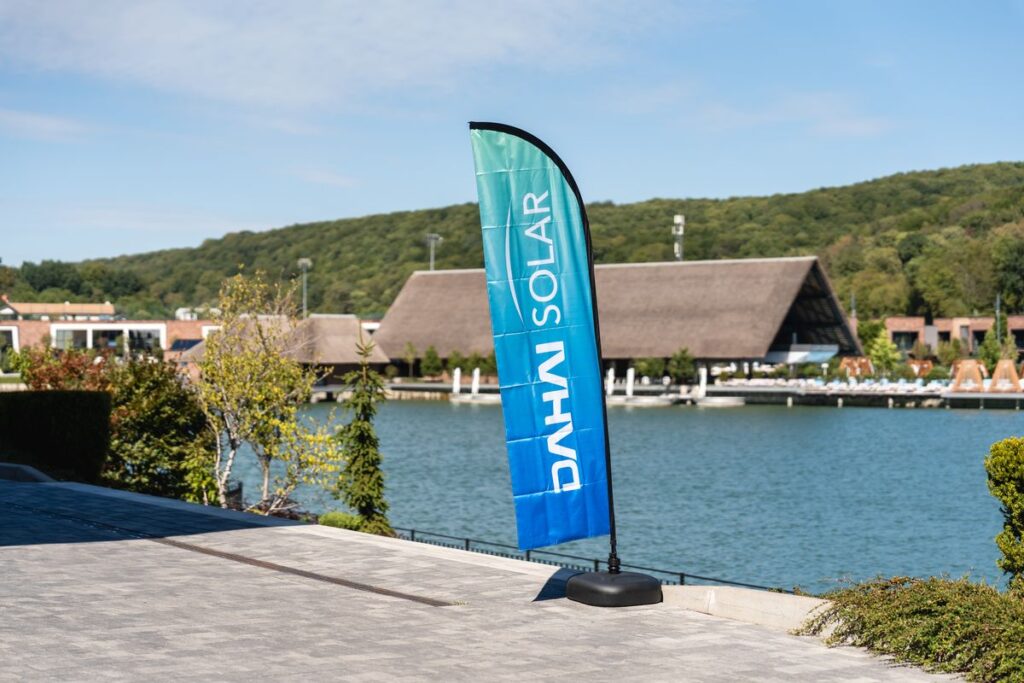 A DAHAI SOLAR flag by the lake at the launch venue in Lviv